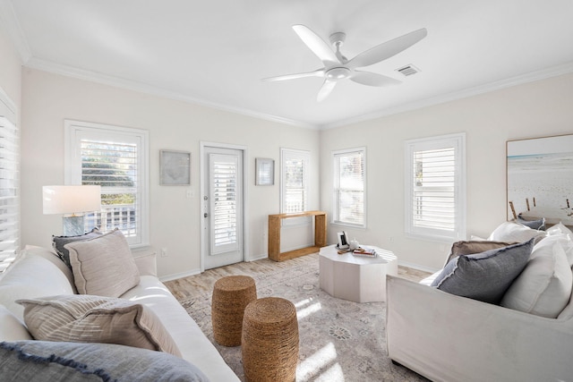 living room with crown molding, light hardwood / wood-style flooring, and ceiling fan