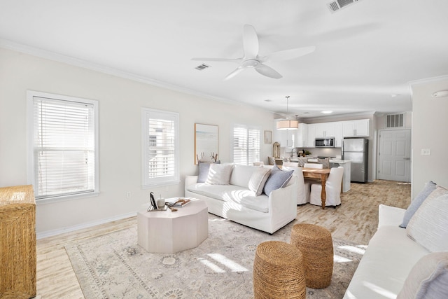 living room featuring light hardwood / wood-style floors, ceiling fan, and ornamental molding