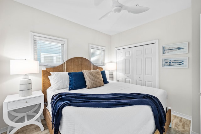 bedroom with ceiling fan, light wood-type flooring, and a closet