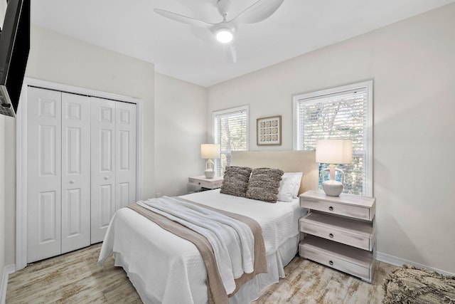 bedroom with ceiling fan, light wood-type flooring, and a closet