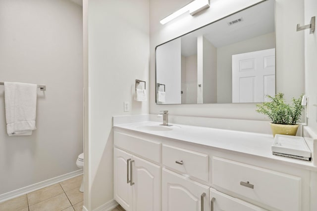 bathroom with tile patterned floors, vanity, and toilet