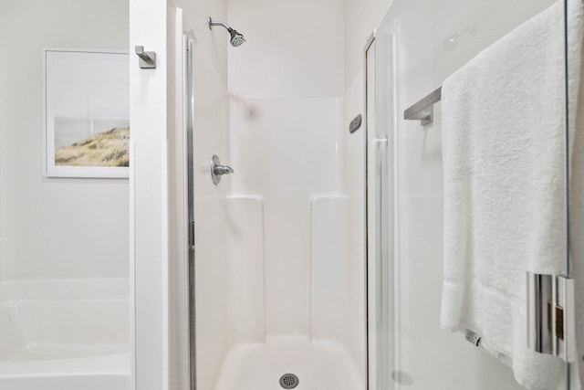 bathroom with a shower with door