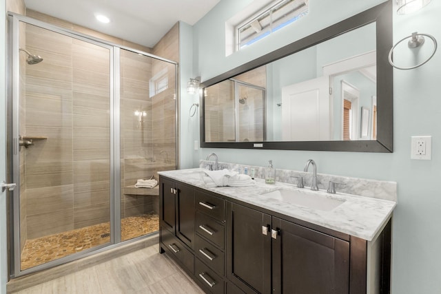 bathroom featuring vanity and an enclosed shower