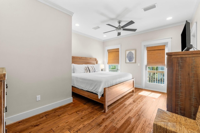 bedroom featuring ceiling fan, ornamental molding, and hardwood / wood-style flooring