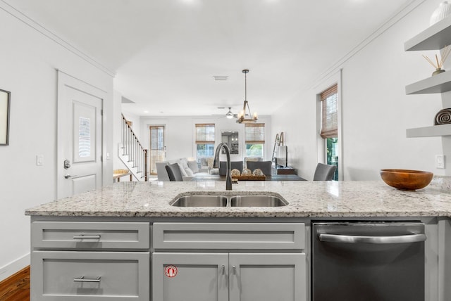 kitchen featuring stainless steel dishwasher, light stone counters, dark hardwood / wood-style flooring, and sink