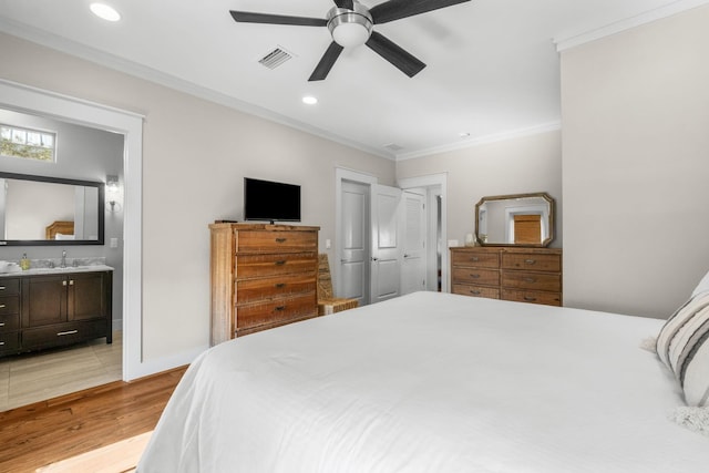 bedroom featuring sink, crown molding, ensuite bath, ceiling fan, and light hardwood / wood-style floors