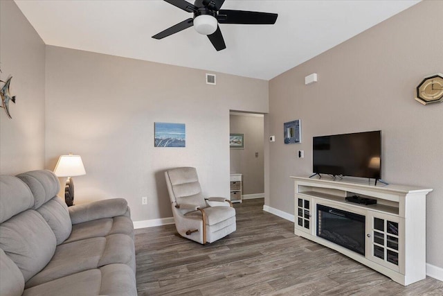 living room featuring hardwood / wood-style flooring and ceiling fan