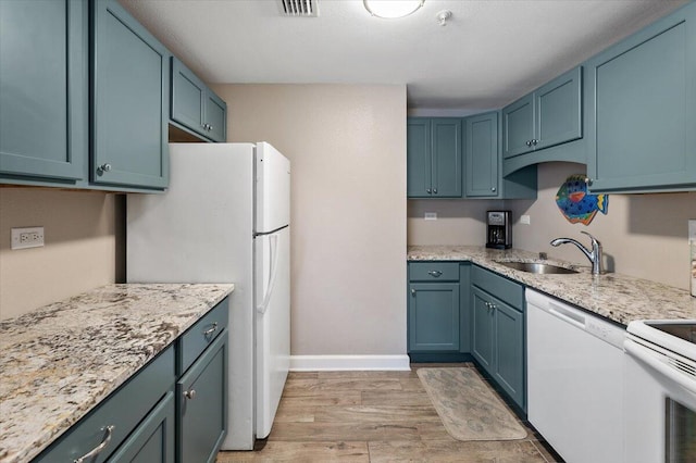 kitchen featuring white appliances, light hardwood / wood-style flooring, blue cabinets, and sink