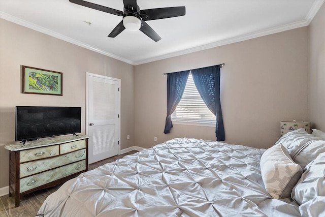 bedroom with ceiling fan, hardwood / wood-style floors, and ornamental molding