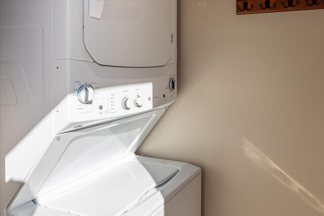 laundry area featuring stacked washer / drying machine