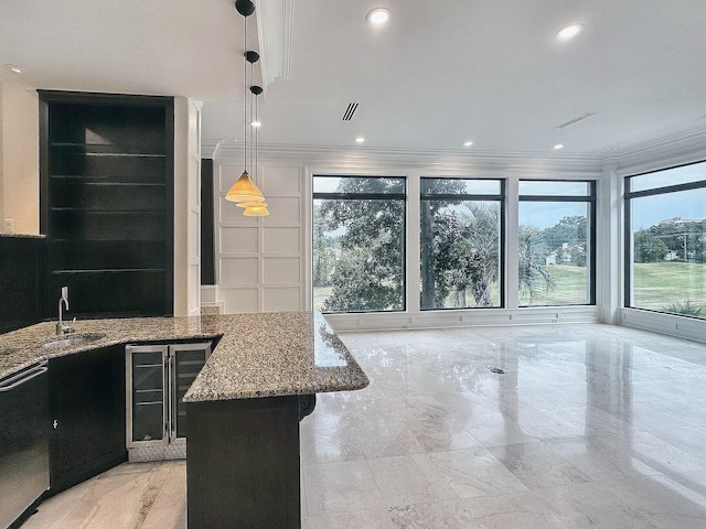 kitchen featuring sink, hanging light fixtures, black dishwasher, a kitchen island, and light stone countertops