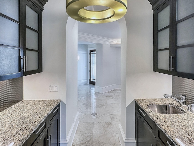 kitchen featuring sink and dark stone countertops