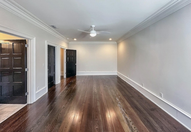 empty room featuring ornamental molding, dark wood-type flooring, and ceiling fan