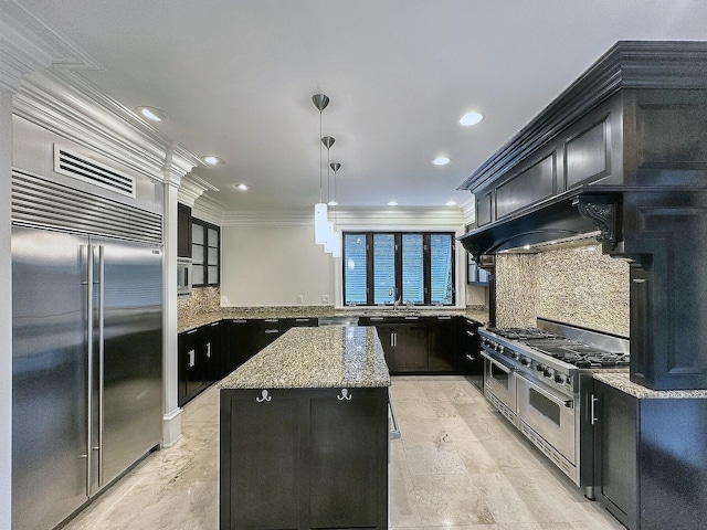 kitchen with light stone counters, crown molding, hanging light fixtures, high quality appliances, and a kitchen island