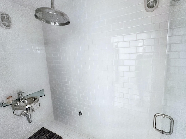 bathroom with tiled shower