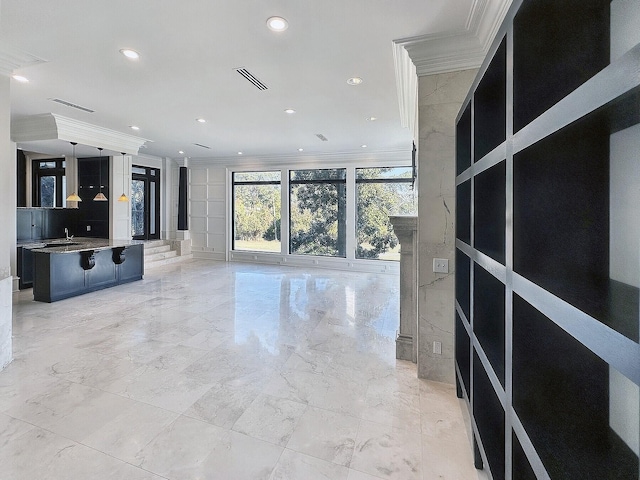 unfurnished living room with crown molding