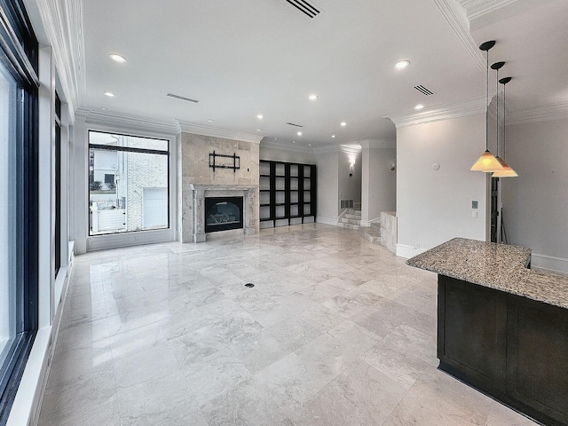 unfurnished living room featuring ornamental molding and a fireplace