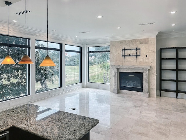 living room with ornamental molding and a high end fireplace