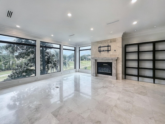 unfurnished living room featuring crown molding and a fireplace