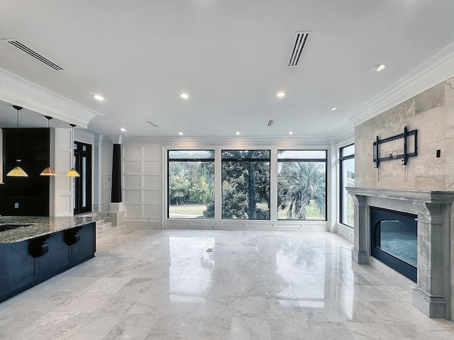 unfurnished living room featuring a premium fireplace and ornamental molding