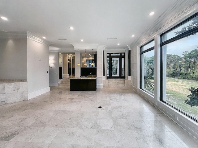 unfurnished living room featuring crown molding