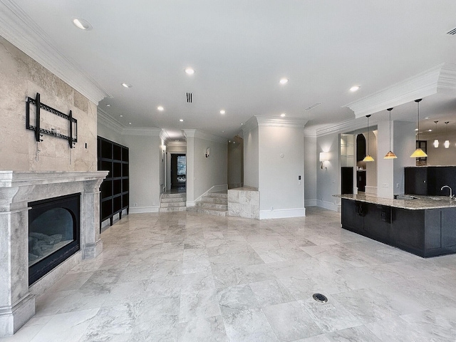 unfurnished living room with crown molding and a fireplace