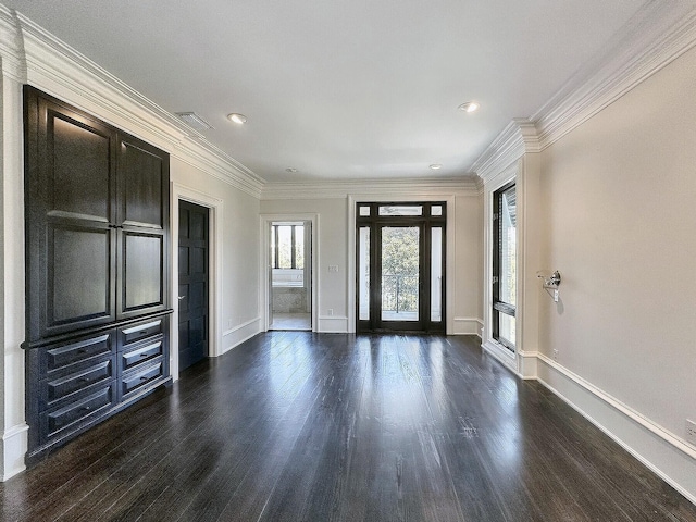 foyer entrance with ornamental molding and dark hardwood / wood-style floors