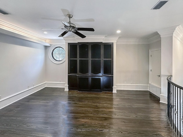 unfurnished room featuring dark wood-type flooring, ornamental molding, and ceiling fan