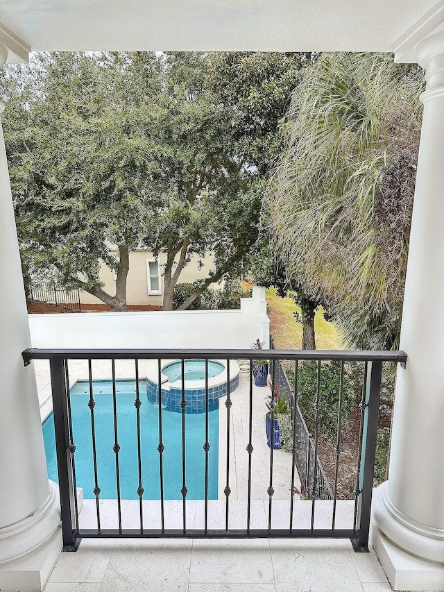 balcony featuring an in ground hot tub