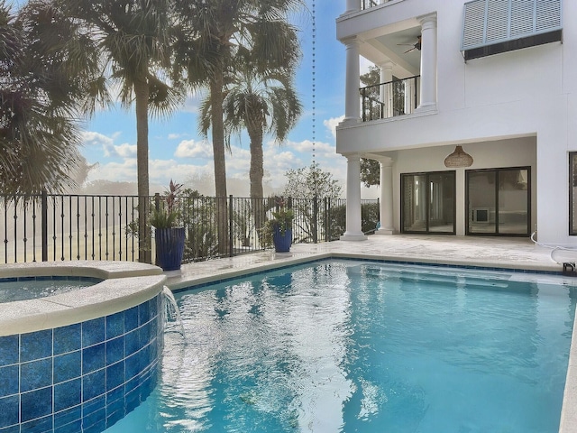 view of swimming pool with an in ground hot tub, ceiling fan, central air condition unit, and pool water feature