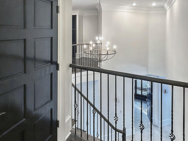 interior space with crown molding and a chandelier