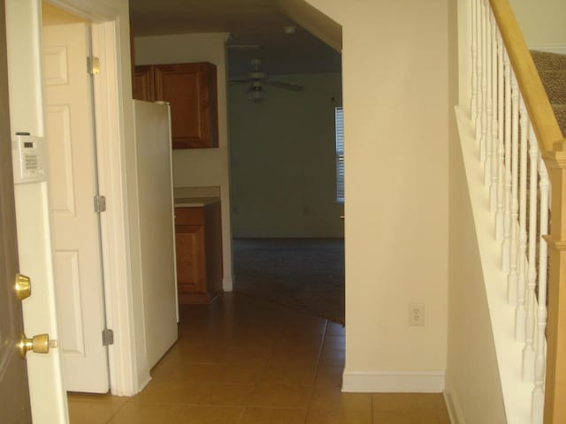 hall featuring light tile patterned floors