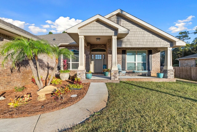 view of front of house with a front lawn and a porch