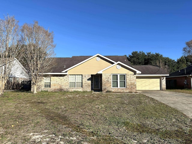 ranch-style house featuring a front lawn and a garage