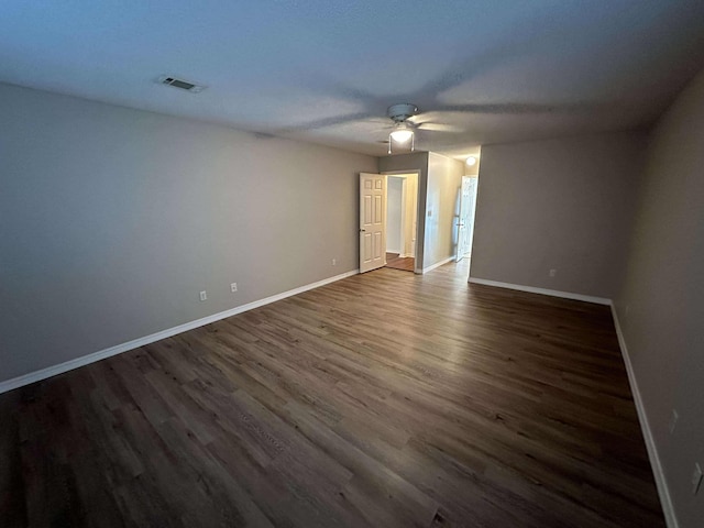 unfurnished room featuring ceiling fan and dark hardwood / wood-style floors