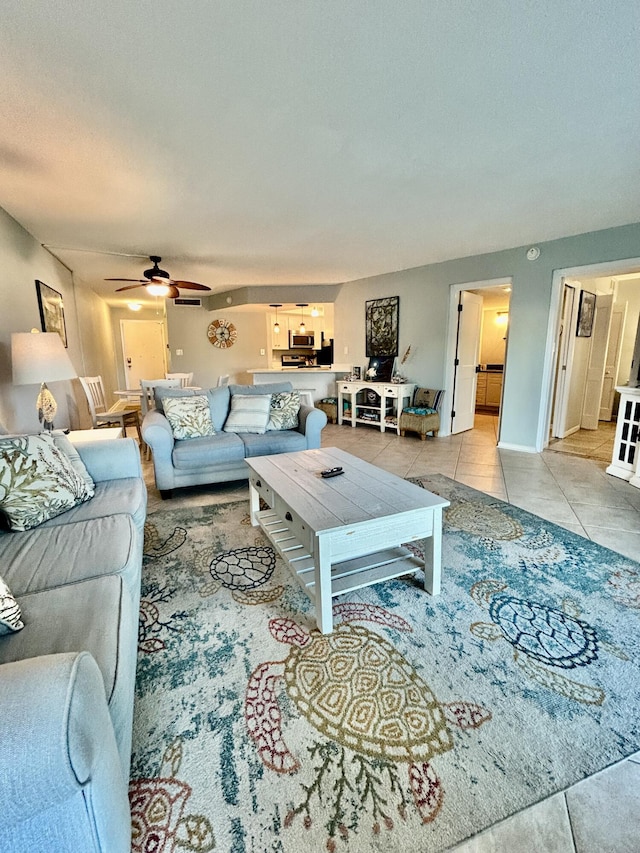 tiled living room featuring ceiling fan