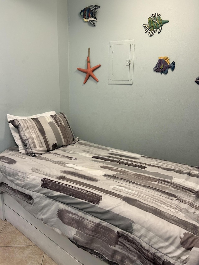 bedroom with light tile patterned floors and electric panel