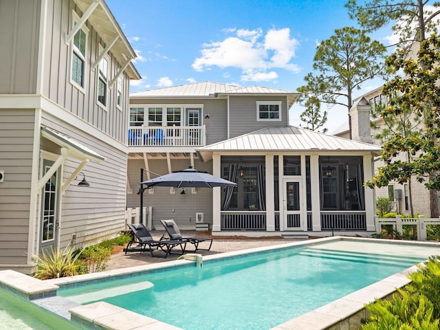 back of property featuring a patio and a sunroom