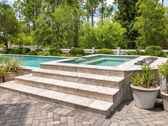 view of pool with an in ground hot tub