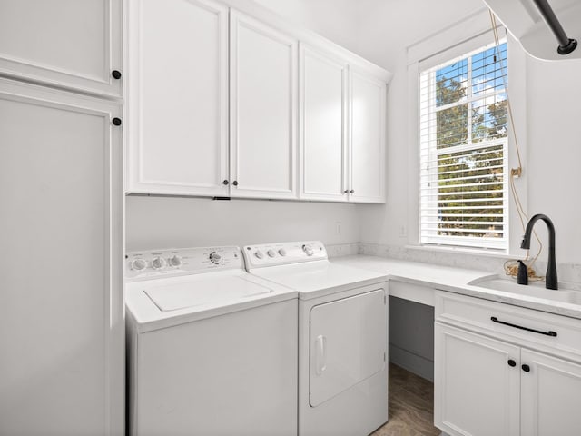 clothes washing area with plenty of natural light, cabinets, independent washer and dryer, and sink