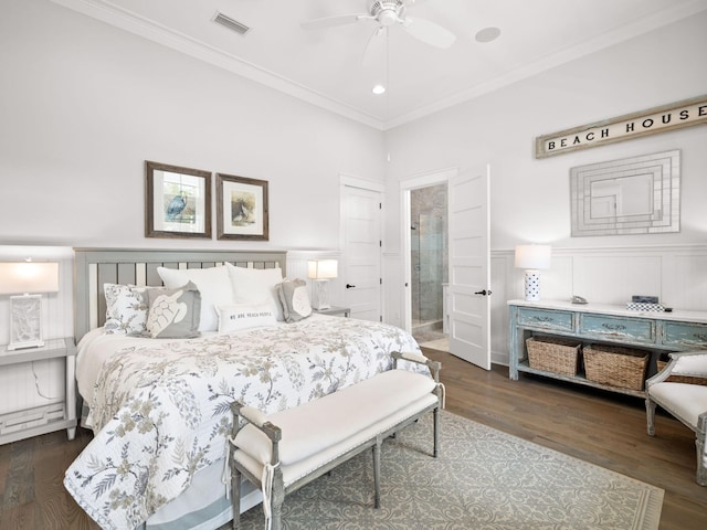 bedroom with ceiling fan, dark hardwood / wood-style floors, crown molding, and ensuite bath