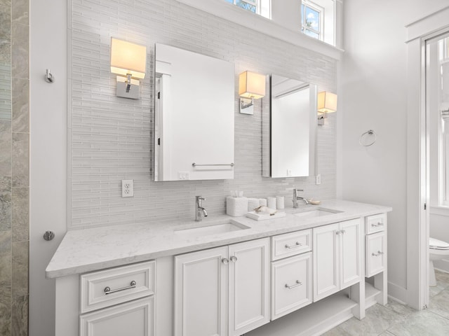 bathroom with decorative backsplash, vanity, toilet, and tile patterned flooring