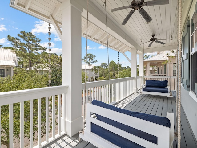 wooden deck featuring ceiling fan