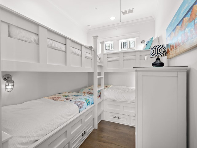 bedroom featuring crown molding and dark hardwood / wood-style flooring