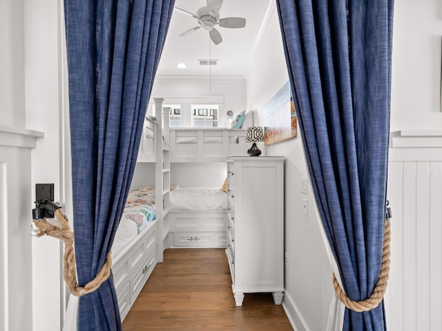 bedroom featuring dark hardwood / wood-style floors, ceiling fan, and crown molding