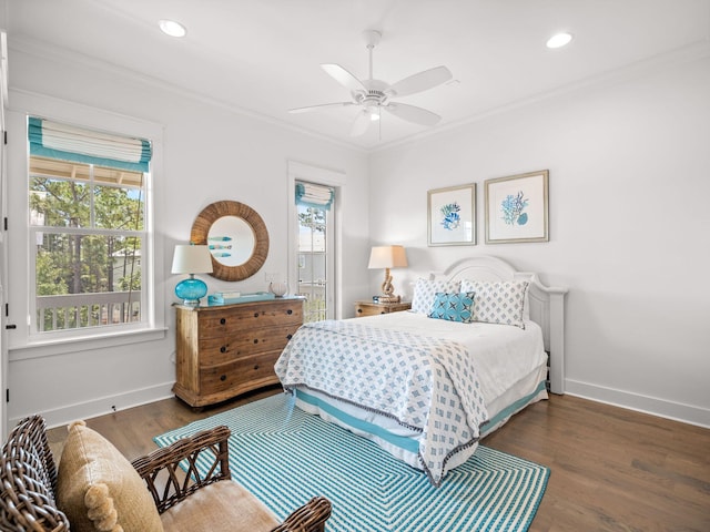 bedroom with dark hardwood / wood-style flooring, ceiling fan, and crown molding