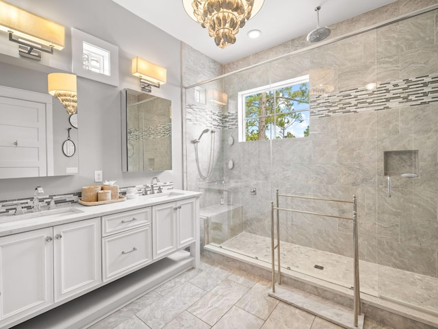 bathroom featuring a shower with door, vanity, and a chandelier