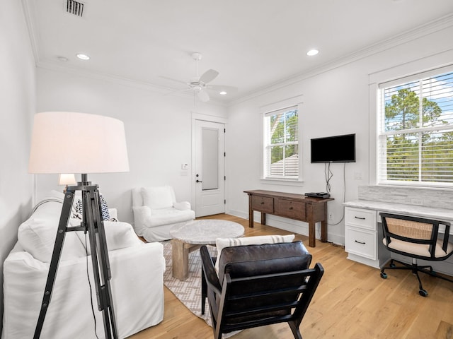 living room with light hardwood / wood-style flooring, a wealth of natural light, and ceiling fan