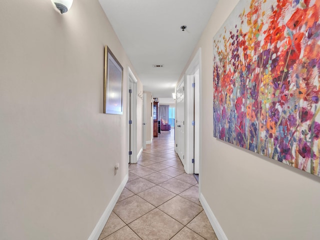 corridor featuring light tile patterned floors