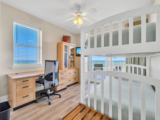 bedroom featuring multiple windows, ceiling fan, and light wood-type flooring